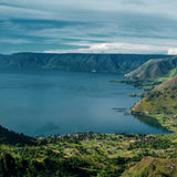 Scenic view of Lake Toba in Sumatra, showcasing lush greenery and mountainous landscapes.