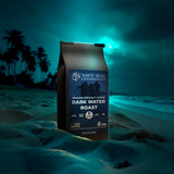 Navy SEAL Foundation Dark Water Roast coffee bag on a beach at night